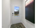 Bright entryway with a white door and large art piece at 1301 White Verona Way, Knightdale, NC 27545