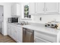 Modern kitchen with stainless steel appliances and white cabinets at 1416 Chambers Rd, Rougemont, NC 27572