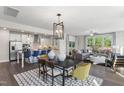 Open concept dining area with modern light fixtures and hardwood floors at 223 Augusta Pond Way # 158, Raleigh, NC 27603