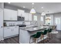 Modern kitchen with white cabinets, granite countertops, and a large island at 773 Denburn Pl, Raleigh, NC 27603