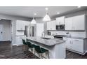 Modern kitchen with white cabinets, granite countertops, and a large island at 773 Denburn Pl, Raleigh, NC 27603