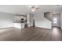 Open living room with kitchen island, hardwood floors, and stairs at 107 Scoville St, Oxford, NC 27565