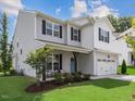 Two-story house with gray siding, white trim, and a two-car garage at 144 Pascoli Ct, Clayton, NC 27527