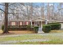 Tan mobile home with red shutters and a spacious yard at 1705 Old Nc 10 Hwy, Hillsborough, NC 27278