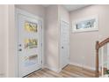 Modern entryway with glass front door and coat closet at 1917 A Essex, Durham, NC 27704