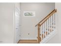 Modern staircase with wooden handrail and white risers at 1917 B Essex Rd, Durham, NC 27704