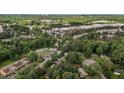 Aerial view of homes and businesses nestled in a wooded area with nearby shopping at 2124 N Hills Dr, Raleigh, NC 27612