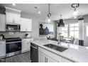 Modern kitchen with white cabinets, granite countertops, and stainless steel appliances at 295 Broomside Ave, Raleigh, NC 27603