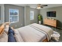 Virtually staged bedroom with a dresser, large bed, and two windows at 311 Burnette St, Durham, NC 27707