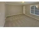 Spacious carpeted bedroom with large window at 311 Burnette St, Durham, NC 27707