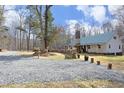 White farmhouse with a green metal roof, stone accents, and a gravel driveway at 540 Patterson Dr, Chapel Hill, NC 27516