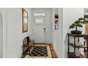 Bright entryway with wood floors, bench, and mirror at 5503 Rutherford Close, Pittsboro, NC 27312