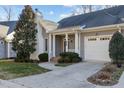 Gray home with white garage door and brick walkway at 5503 Rutherford Close, Pittsboro, NC 27312