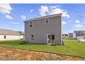 Gray siding, sliding glass door, and small backyard at 704 Rhino Bnd, Oxford, NC 27565