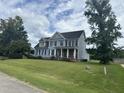 Two-story house with blue siding, black shutters, and a spacious lawn at 7513 Orchard Crest Ct, Apex, NC 27539