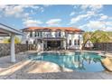 Inviting kidney-shaped pool with a large patio area at 105 Kingfisher Way, Louisburg, NC 27549
