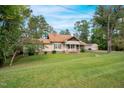Ranch-style home with a well-maintained lawn and landscaping at 1521 Cross Link Rd, Raleigh, NC 27610