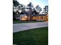 House exterior view at dusk, showcasing a large porch and driveway at 1521 Cross Link Rd, Raleigh, NC 27610