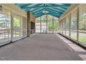 Spacious screened porch with brick fireplace and blue ceiling at 1521 Cross Link Rd, Raleigh, NC 27610