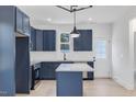 Modern kitchen with dark blue cabinets, granite countertops, and stainless steel appliances at 206 3Rd St, Erwin, NC 28339