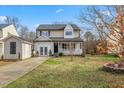 Two-story house with a landscaped lawn, detached shed, and driveway at 4708 River Boat Landing Ct, Raleigh, NC 27604