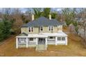 Two-story home with a wrap-around porch and mature trees at 603 W Davis St, Burlington, NC 27215