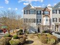 Three story townhome with driveway and landscaped yard at 1674 Snowmass Way, Durham, NC 27713