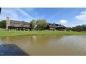Lakefront property with a large home and community pavilion at 30 Hidden Lake Dr, Franklinton, NC 27525