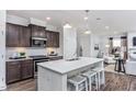 Modern kitchen with dark cabinets, white countertops, and a kitchen island at 47 Rosedale Way, Pittsboro, NC 27312