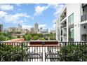 Private balcony with city view and small table with chairs at 523 S West St # 402, Raleigh, NC 27601