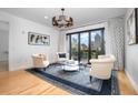 Light-filled living room with three chairs and a city view at 523 S West St # 402, Raleigh, NC 27601