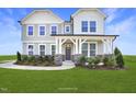 Two-story house with gray siding, stone accents, and a landscaped yard at 1817 Ballard Rd # Selma English Country, Fuquay Varina, NC 27526