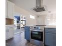 Modern kitchen with stainless steel appliances and white cabinets at 2407 Hart St # A, Durham, NC 27703
