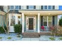 Inviting front porch with a red chair and a dark wooden front door at 281 Lasater Rd, Bunnlevel, NC 28323