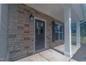 Front entrance with stone facade and a dark brown door at 6100 Sunset Lake Road Rd, Fuquay Varina, NC 27526