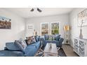 Cozy living room featuring blue couches and large windows at 835 Graham St, Burlington, NC 27217