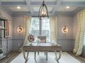 Home office features hardwood floors, large windows, and a stylish desk at 817 Heartpine Dr, Mebane, NC 27302