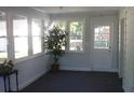 Bright sunroom with multiple windows and carpet flooring at 1631 Granville St, Burlington, NC 27215