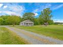 Ranch home with gravel driveway and a view of the landscape at 1152 Pagetown Rd, Elon, NC 27244