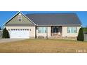 Beige and green two-story home with attached garage at Lot 37 Long St, Broadway, NC 27505