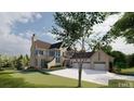 Grand home with three-car garage and manicured lawn at 1419 Ridge Rd, Raleigh, NC 27607