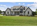 Modern farmhouse exterior with metal roof at 8917 Grand Highland Way, Wake Forest, NC 27587