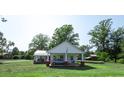 Quaint house with a carport and mature trees at 10782 S Nc 62 Hwy, Burlington, NC 27217