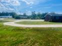 Landscaped yard with curved driveway and brick home at 2164 Ray Rd, Spring Lake, NC 28390