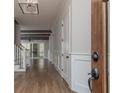 Bright entryway with hardwood floors and view into the living room at 1117 Old Lystra Rd, Chapel Hill, NC 27517