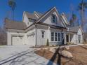 Two-story farmhouse with white siding, stone accents, and a large driveway at 1117 Old Lystra Rd, Chapel Hill, NC 27517