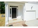Front entrance with black door, brick steps, and white siding at 804 N Magnolia Ave, Dunn, NC 28334