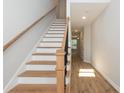 Modern staircase with wood treads and metal railing at 804 N Magnolia Ave, Dunn, NC 28334