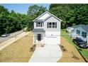 Two-story house with gray siding, white trim, and a two-car garage at 804 N Magnolia Ave, Dunn, NC 28334