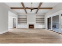 Spacious living room featuring hardwood floors, fireplace, and built-in shelving at 8417 Portmarnock Ct, Wake Forest, NC 27587